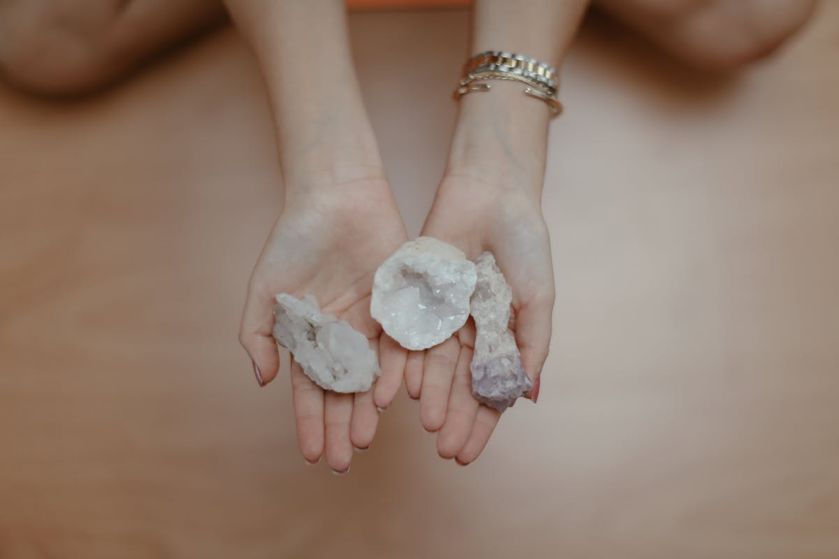 Someone holding multiple crystals in their palm