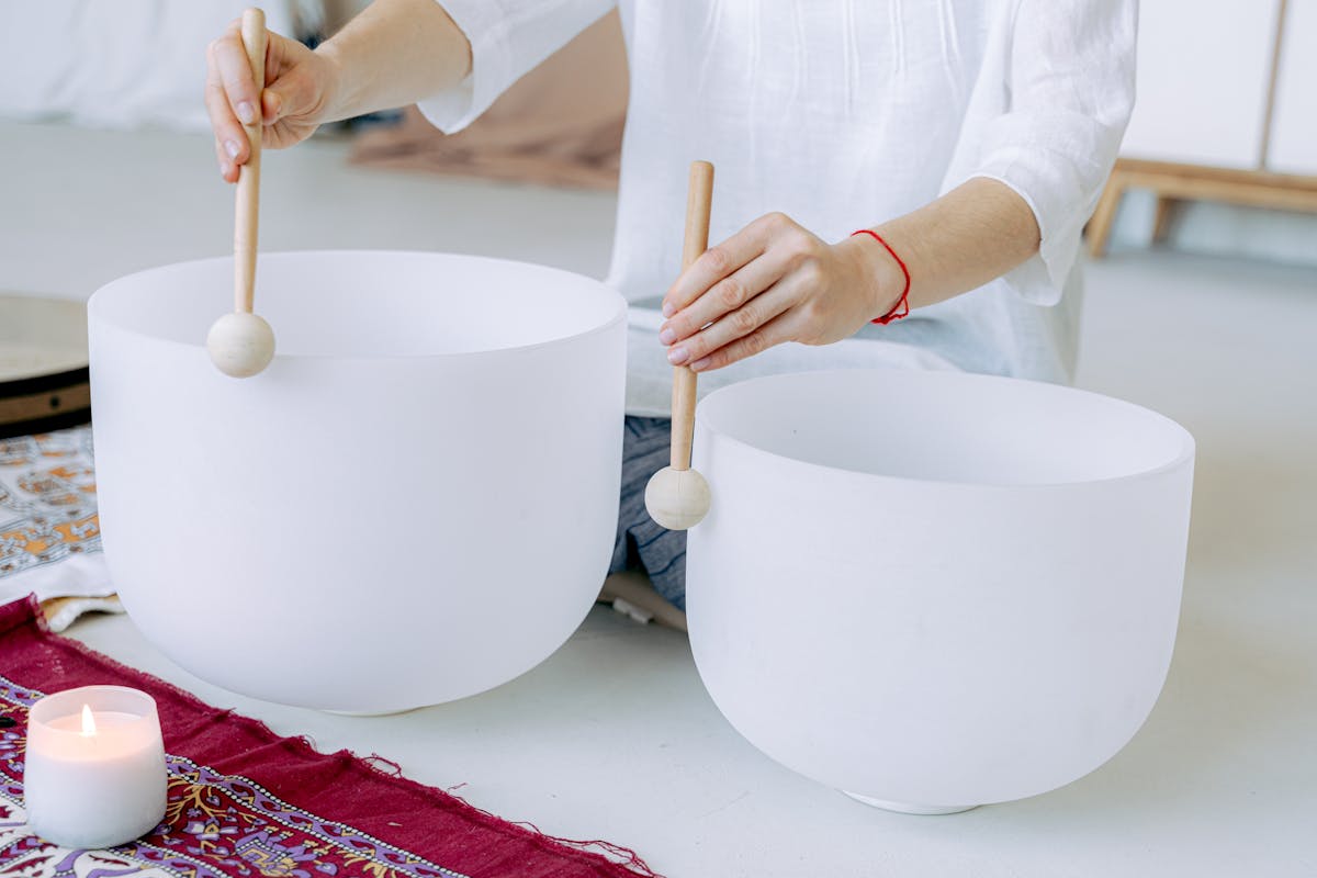 Vibration healing bowls that a person is using